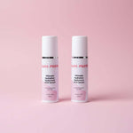 Two bottles of 'Bliss Forte' serum on a reflective surface with a purple background