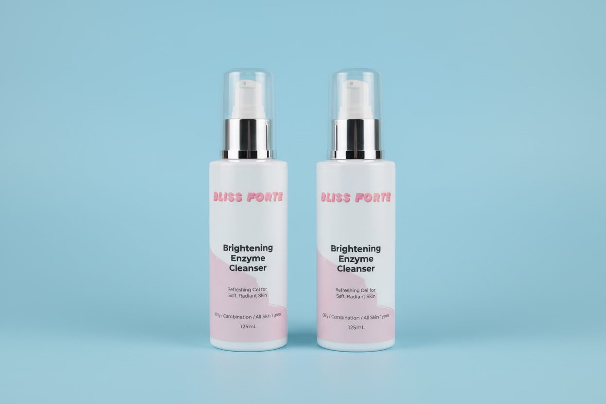 Two bottles of Bliss Forte Brightening Enzyme Cleanser on a green towel with a wooden background.