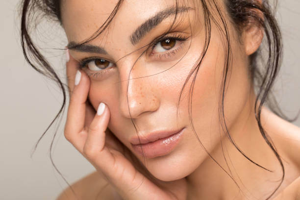 Close-up of a woman with glowing skin, showcasing a healthy complexion and natural beauty, ideal for skin care promotion.